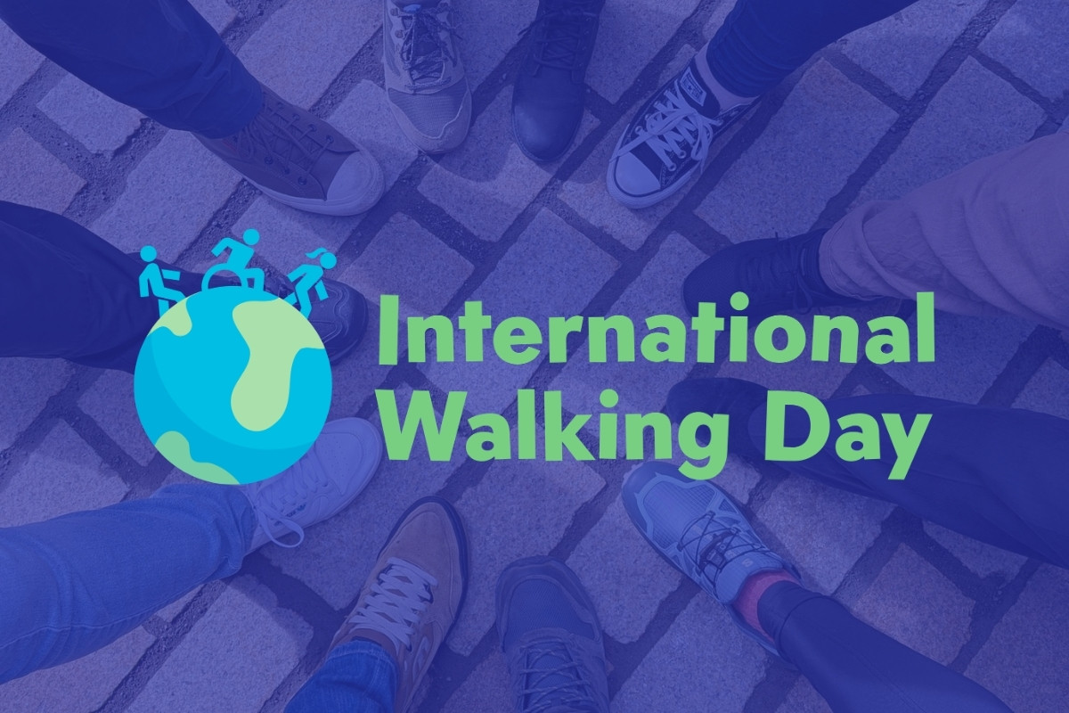 The International Day of Walking logo on a blue background.